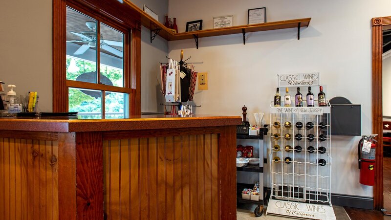 Host counter with bottles of wine on a rack